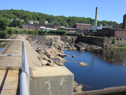 Otis Hydro Dam in Jay with no water flowing. The Otis Mill in the background.
